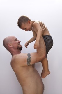 Caucasian father holding son