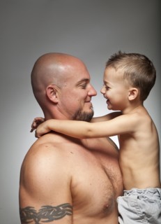 Caucasian father holding son