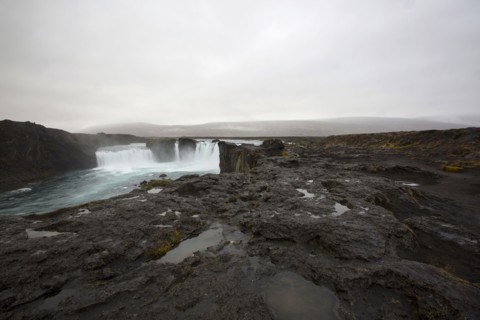 Rock formation cliffs near remote waterfall