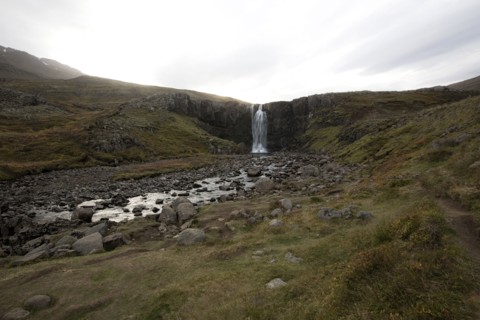 Waterfall and rocky stream in remote field