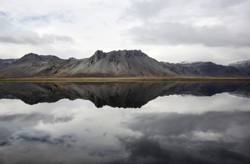Mountains reflecting in still lake