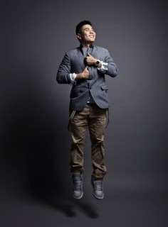 Chinese man wearing jacket and jumping