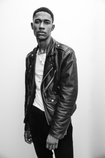 Portrait of serious Black man wearing leather jacket