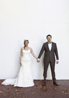 Serious Caucasian bride and groom holding hands