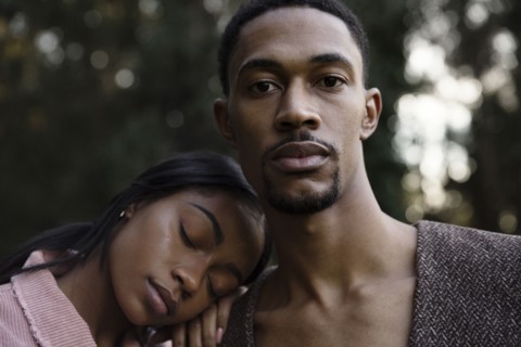 Woman resting head on shoulder of man