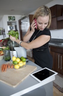 Caucasian businesswoman juicing in kitchen