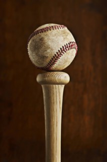 Baseball balancing on baseball bat