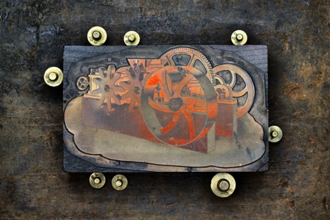 Close up of letter press wood block and gold weights