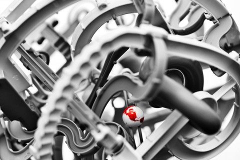 Close up globe among gears in machine
