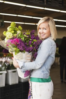 Caucasian woman carrying bouquet of flowers