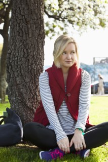 Caucasian woman sitting by tree in park
