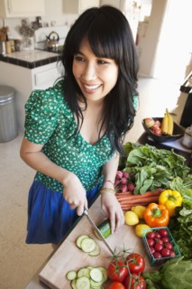 Woman chopping vegetables in kitchen
