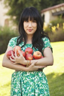 Woman holding armfuls of fruit