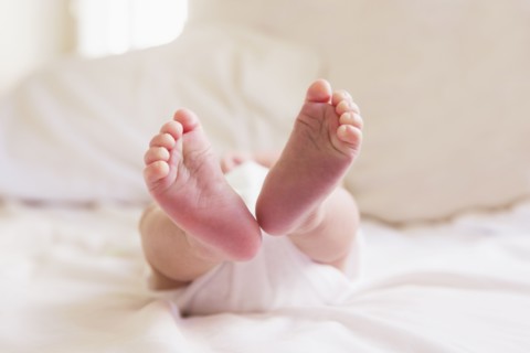 Close up of feet of mixed race baby