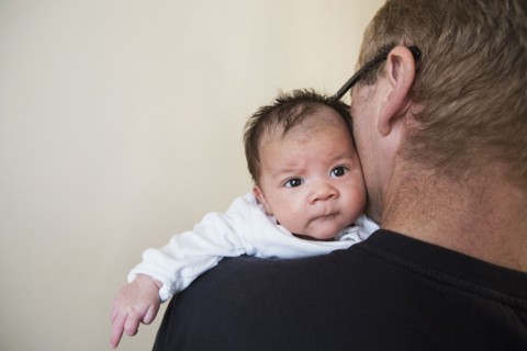 Close up of father holding mixed race baby