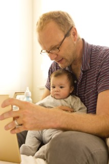 Father reading to baby boy