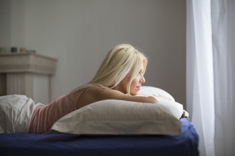 Caucasian woman laying in bed