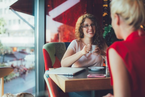 Women drinking coffee together in cafe