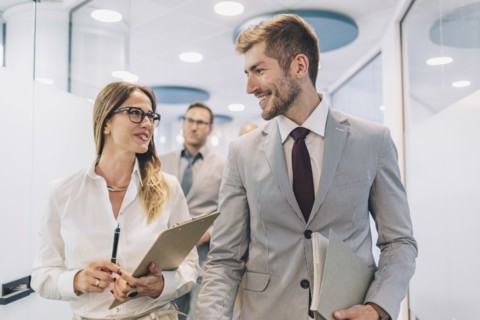 Caucasian business people talking in office corridor