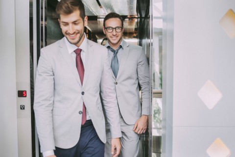 Caucasian businessmen walking out of elevator