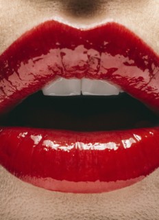 Close up of mouth of woman wearing red lipstick
