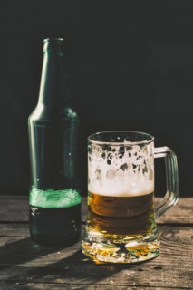 Glass and bottle of beer on table