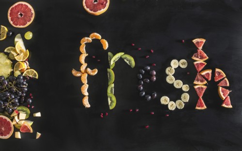 Close up of the word fresh written with sliced fruit