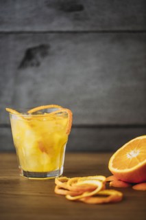 Orange juice with peel and sliced fruit