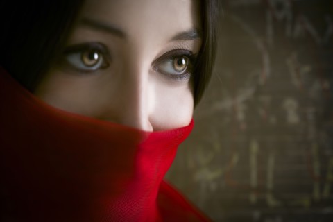 Close up of woman wearing red face scarf