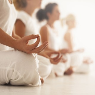 Close up of women meditating in yoga class