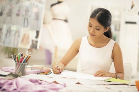 Fashion designer drawing in studio