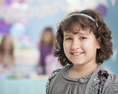 Close up of smiling girl at birthday party