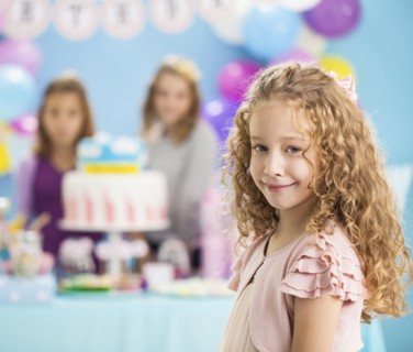 Girl smiling at birthday party