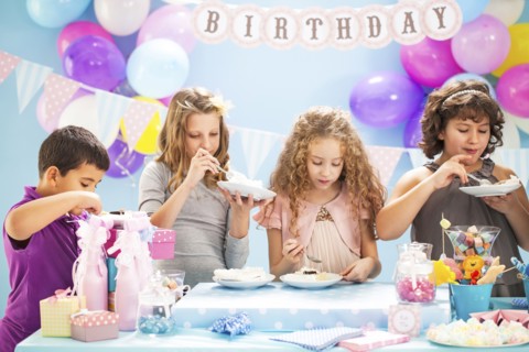 Children eating cake at birthday party