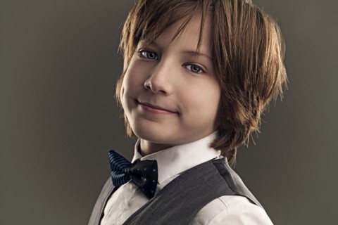 Smiling boy wearing dress shirt and bow tie