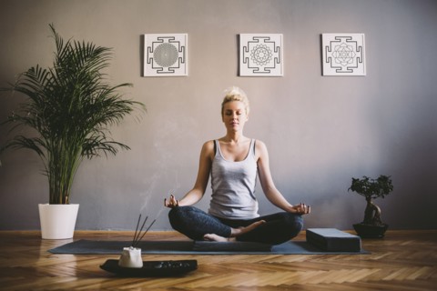 Caucasian woman meditating in yoga studio