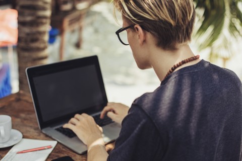 Caucasian man using laptop outdoors