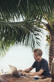 Caucasian man using laptop outdoors
