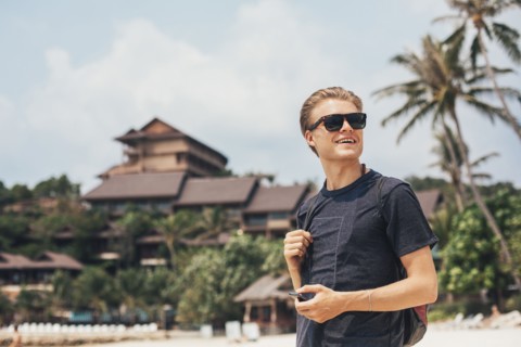 Caucasian man walking on beach