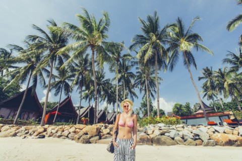 Caucasian woman walking on beach