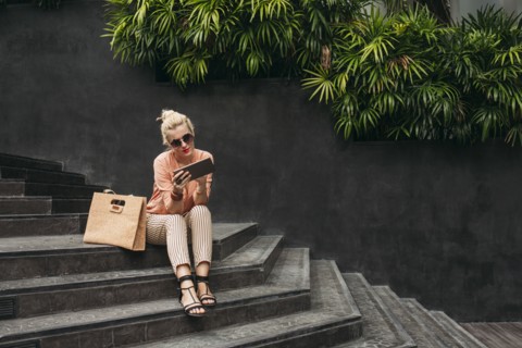 Caucasian woman using digital tablet on stairs