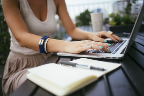 Caucasian woman using laptop outdoors
