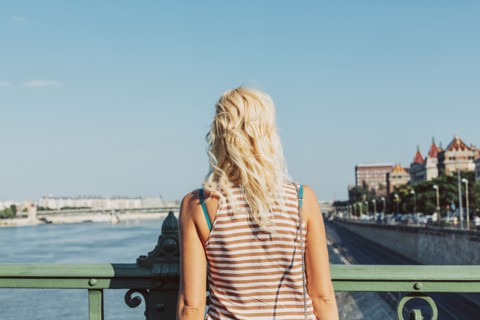 Caucasian woman standing on bridge