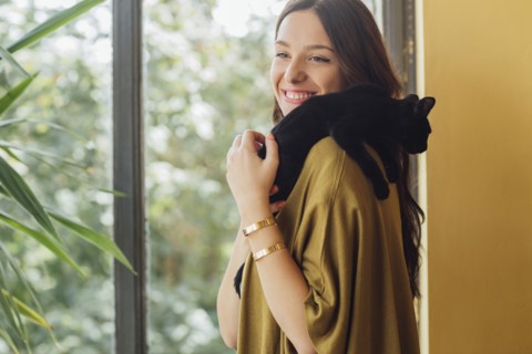 Caucasian woman holding kitten
