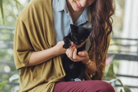 Caucasian woman holding kitten