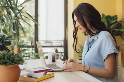 Caucasian woman using laptop at desk