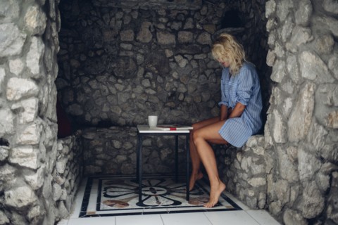 Woman sitting in stone patio