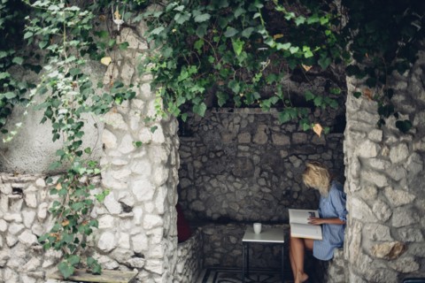 Woman sitting in stone patio