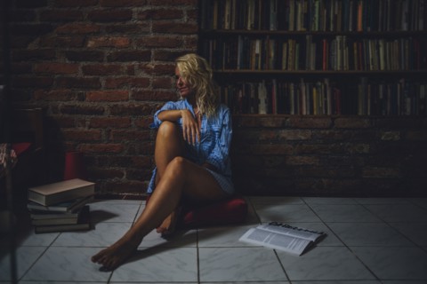 Smiling woman sitting on living room floor