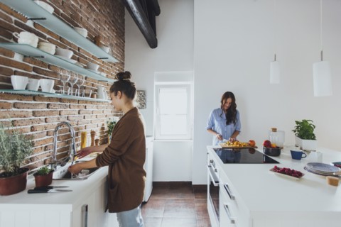 Caucasian women cooking in kitchen